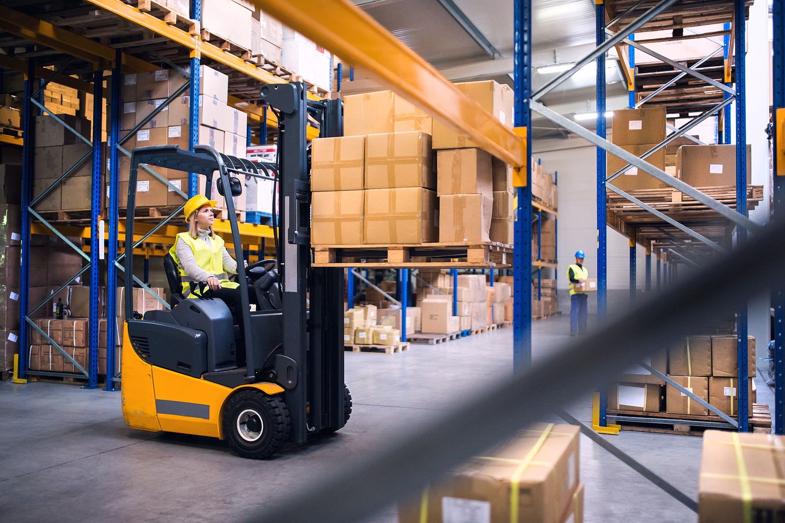 a forklift operator handling boxes in a warehouse